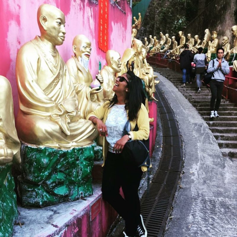 Woman climbing to ten thousand Buddhas monestary Sha Tin, Hong Kong