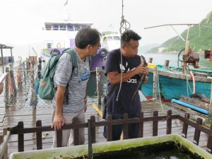 Tour guide holding baby shark on Lamma Island.