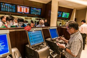 Happy Valley, Hong Kong, China- June 5, 2014: people betting horse races at Happy Valley racecourse