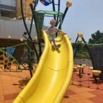 boy on yellow slide at peak galleria playground