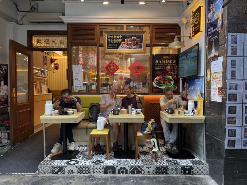Travellers enjoying dim sum at a traditional restaurant in Hong Kong