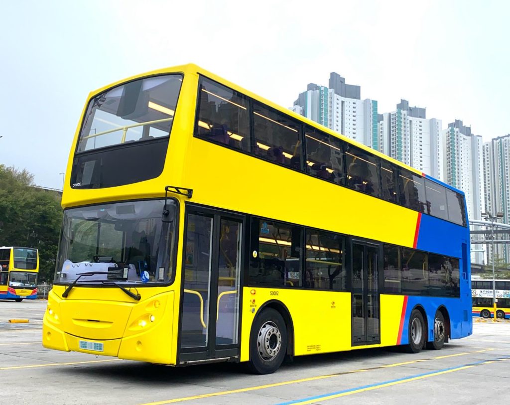Group enjoying a private open-top double-decker bus tour in Hong Kong