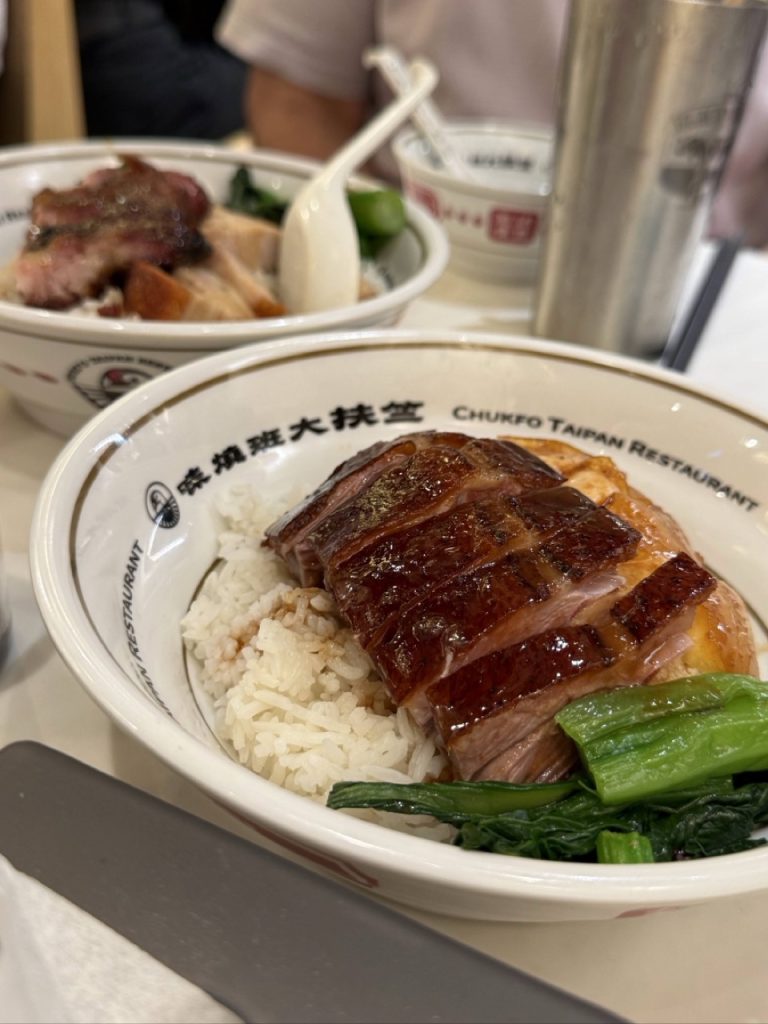 Cantonese roast meat served over rice with Chinese greens in Hong Kong
