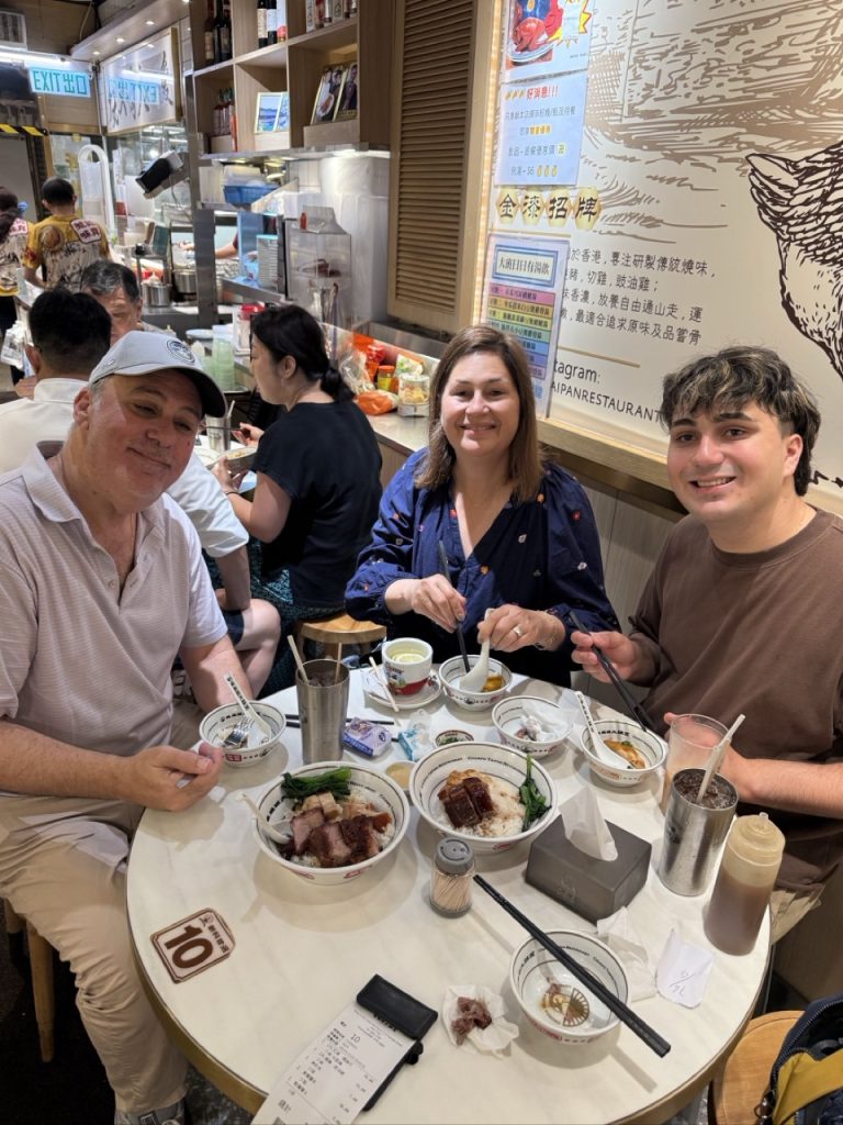 Cruise guests enjoying Cantonese roast meats at a local Hong Kong restaurant