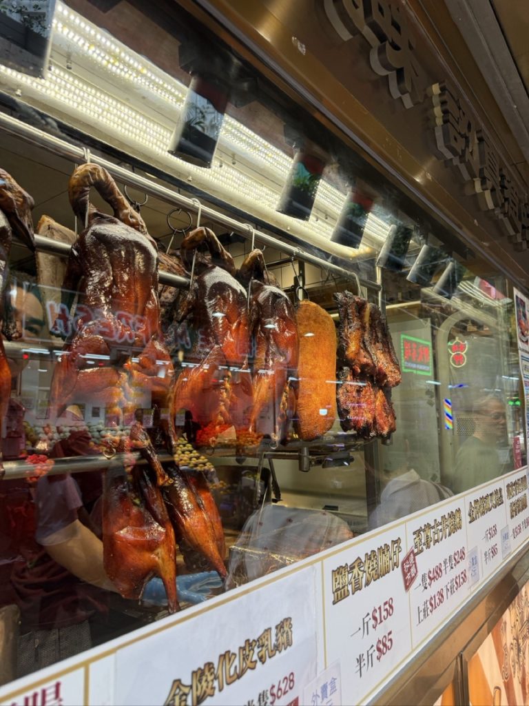 Traditional Cantonese roast meats hanging in a Hong Kong siu mei shop window