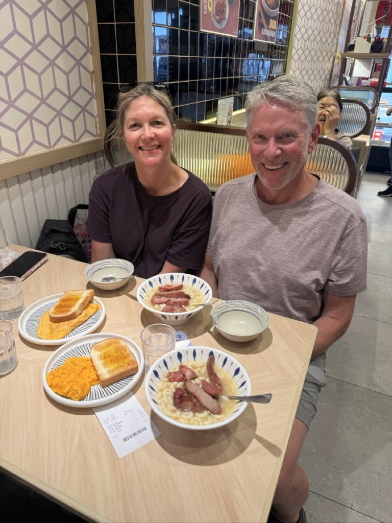 Visitors enjoying char siu macaroni and eggs at a Hong Kong cha chaan teng
