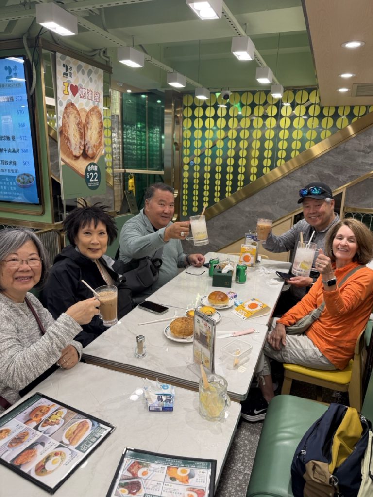 Cruise guests enjoying Hong Kong-style drinks at a local cha chaan teng